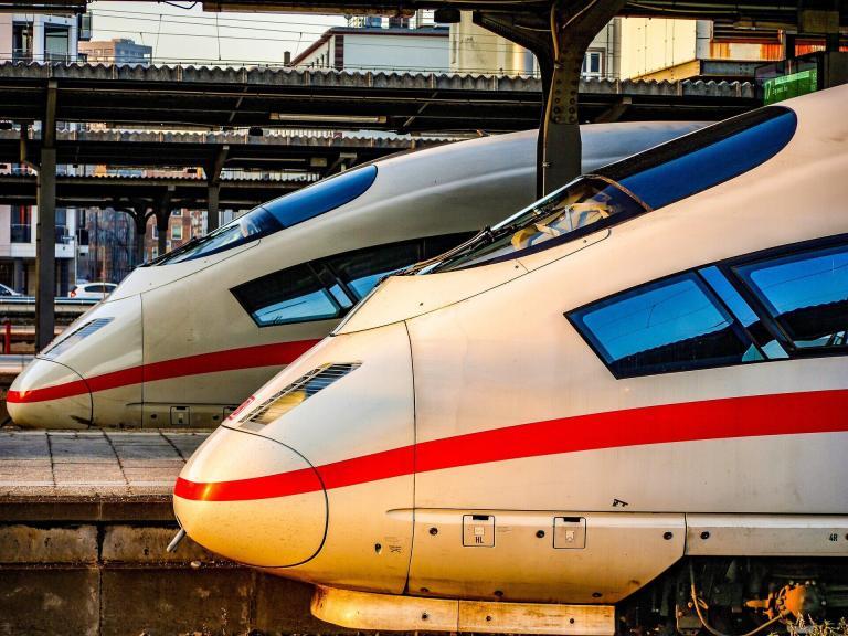 A Two Trains At A Train Station