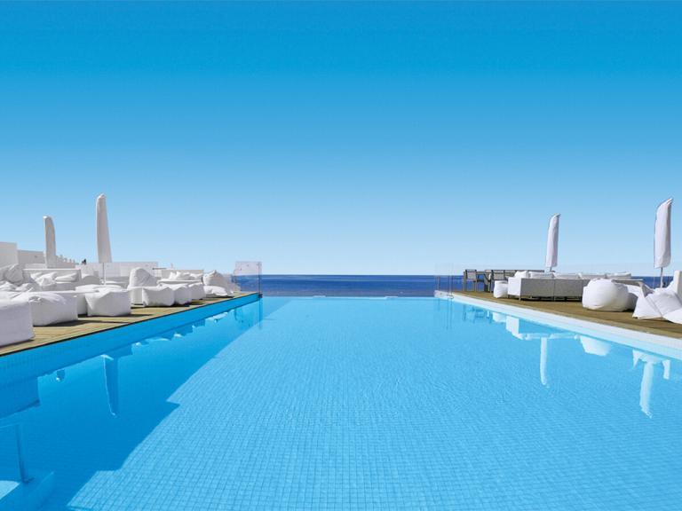 A Pool With A Deck And Chairs And A Deck Chair