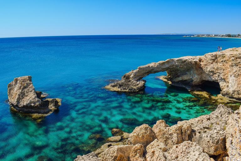 A Rock Formation Over Clear Blue Water