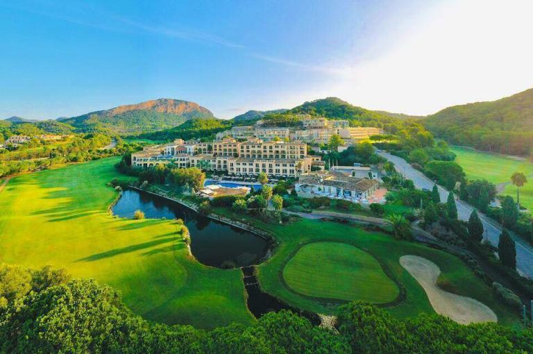 A Golf Course With A Building And A River