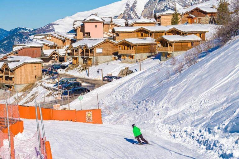 A Person Skiing Down A Snowy Hill