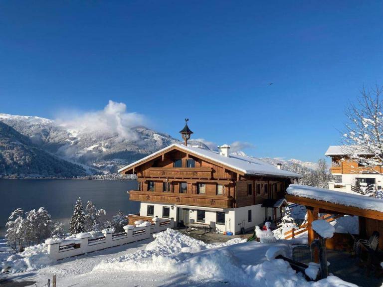 A House With Snow On The Ground With Alyeska Resort In The Background