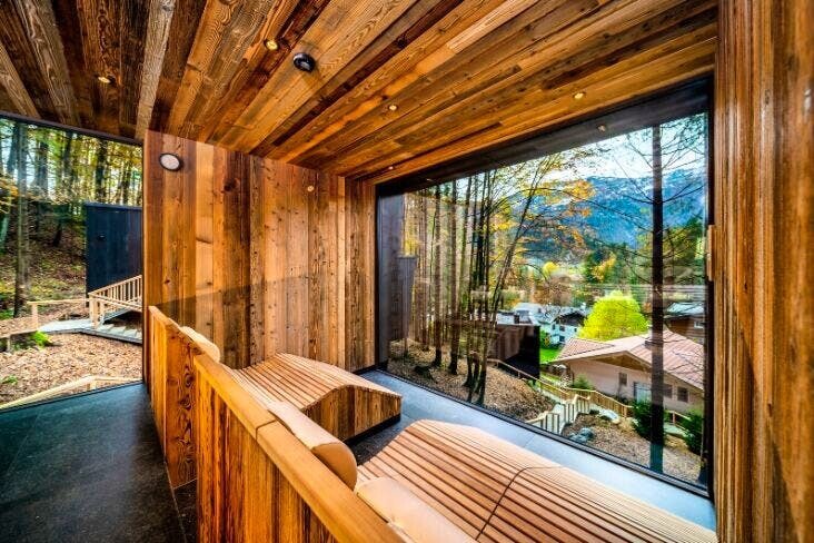 A Room With A Wooden Wall And Windows