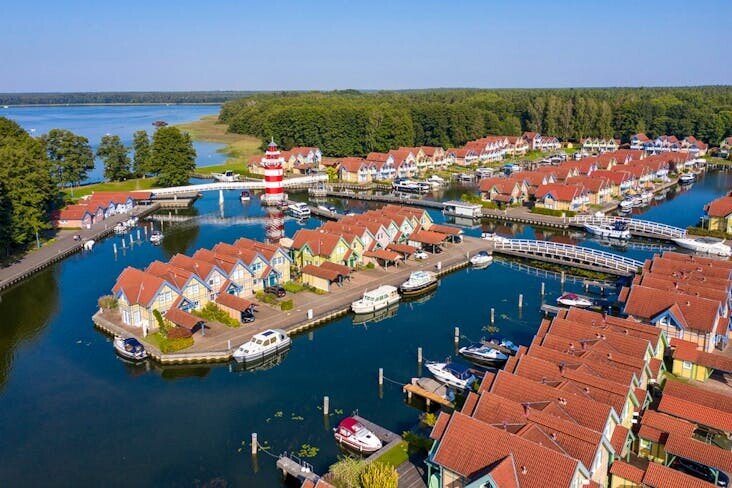 A Group Of Houses On A Body Of Water