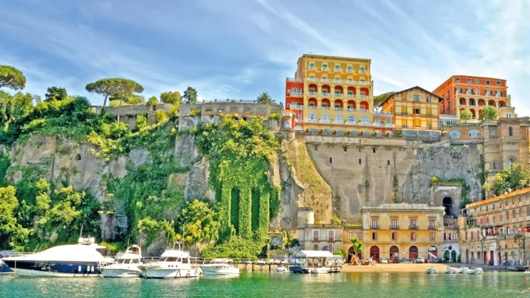 A Body Of Water With Boats And Buildings On The Side