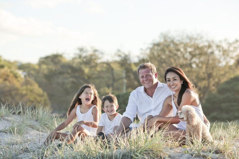 A Family Sitting In The Grass