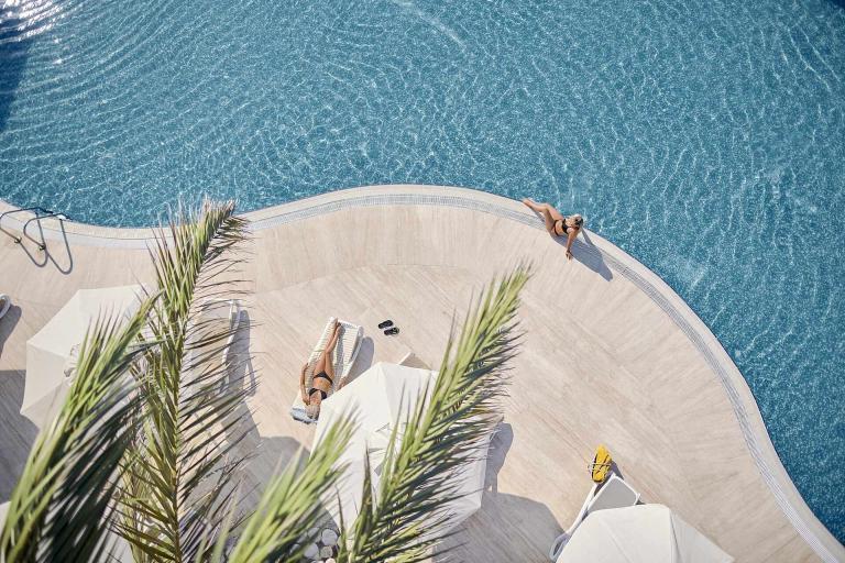 A Group Of People On A Pool Edge