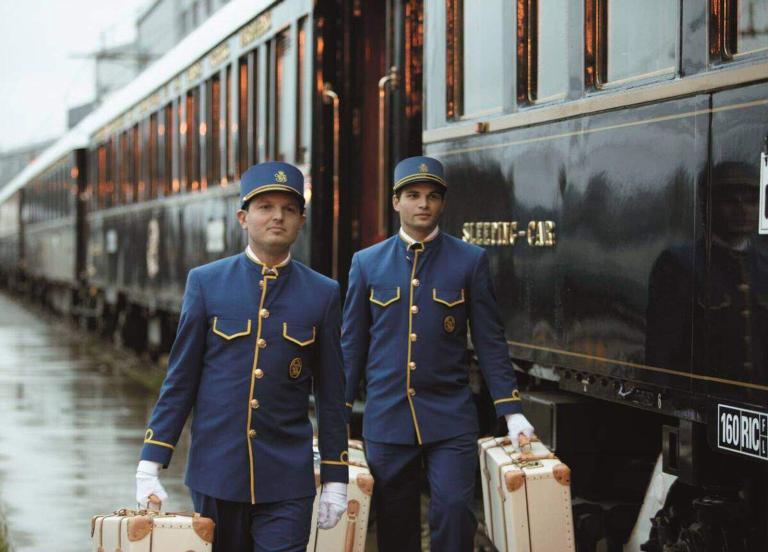 A Couple Of Men In Uniform Holding Luggage