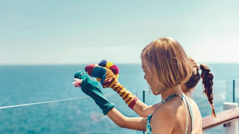 A Girl Wearing Gloves With A Puppet On Her Hand