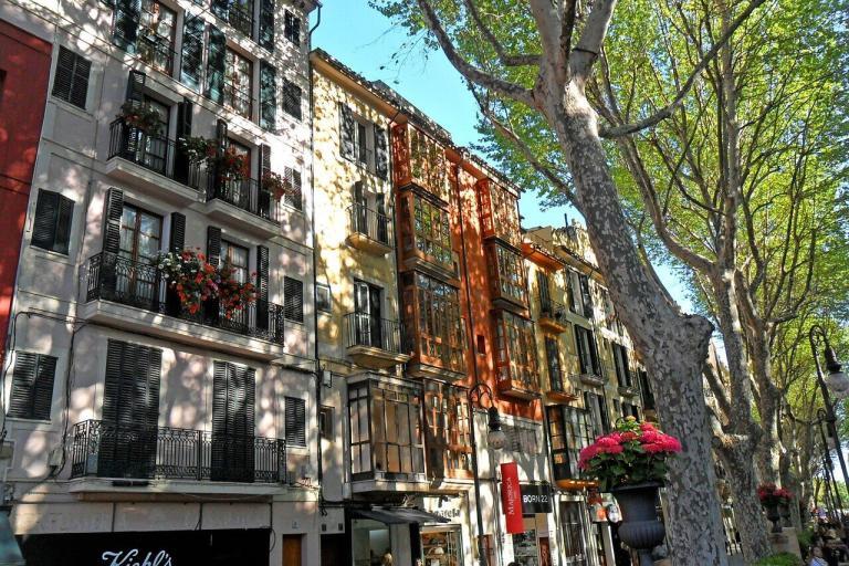 A Row Of Multi-Story Buildings With Flowers