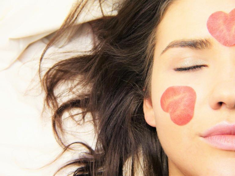 A Woman Lying Down With A Heart On Her Face